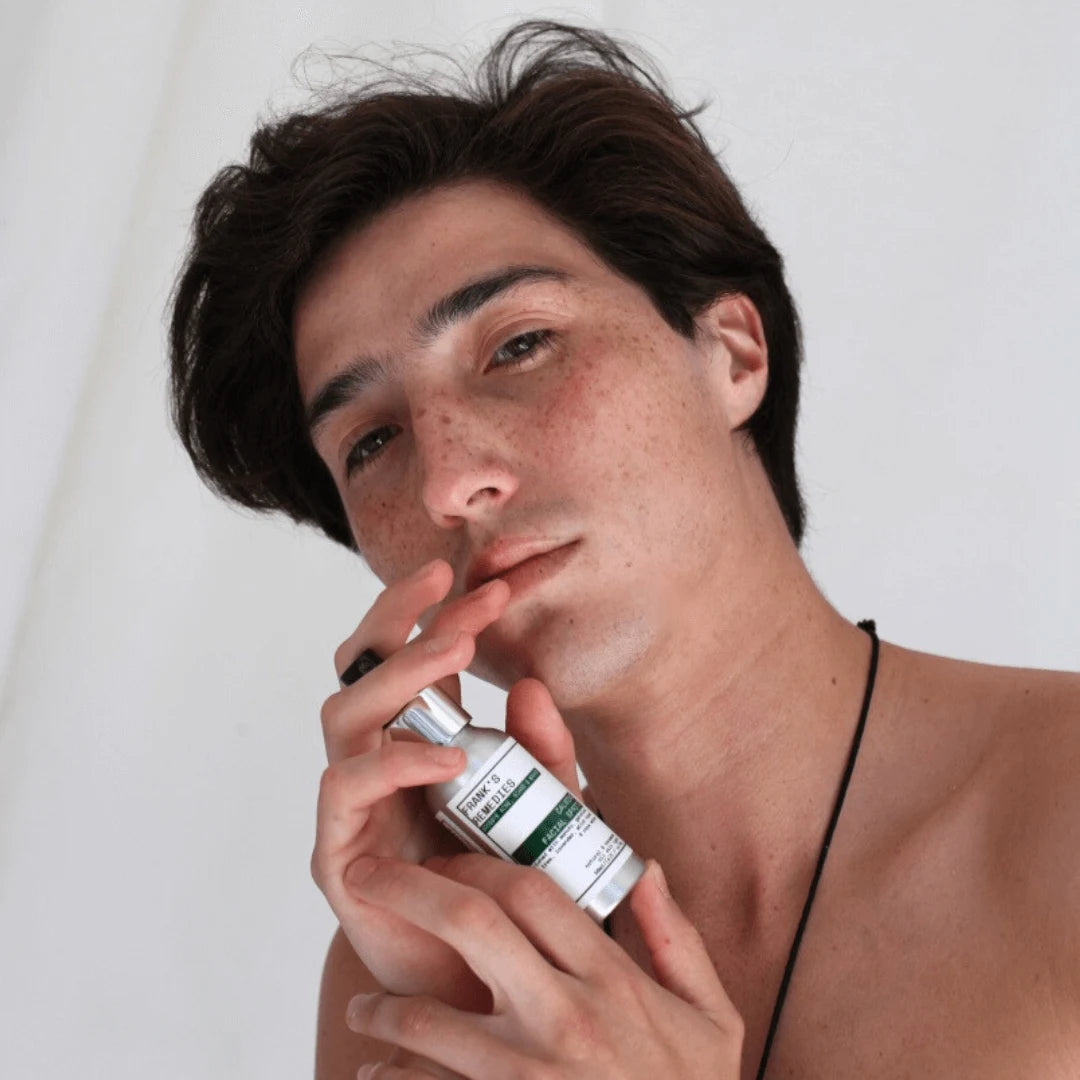 Male model teen holding Antibacterial Face Spray product 
